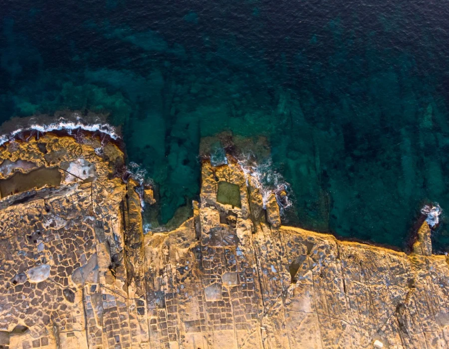 The rocky coastline and clear Mediterranean water at Xghajra