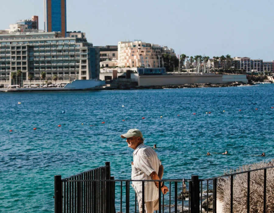 A visitor looking out over the Sliema coastline on a clear day