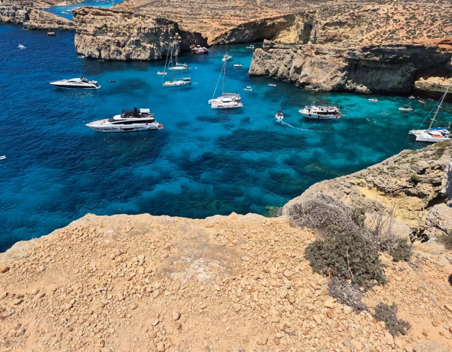 Boats anchored in crystal clear water seen from above