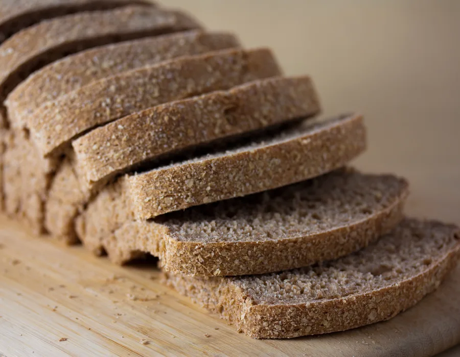 A sliced wholemeal loaf on a board