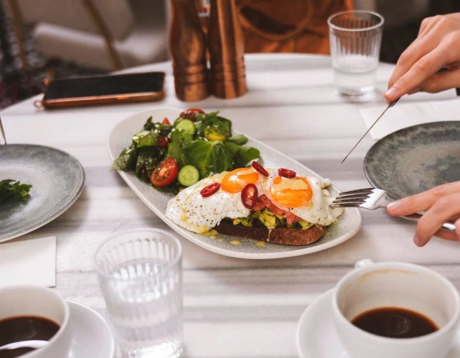 People eating breakfast with coffee at a restaurant