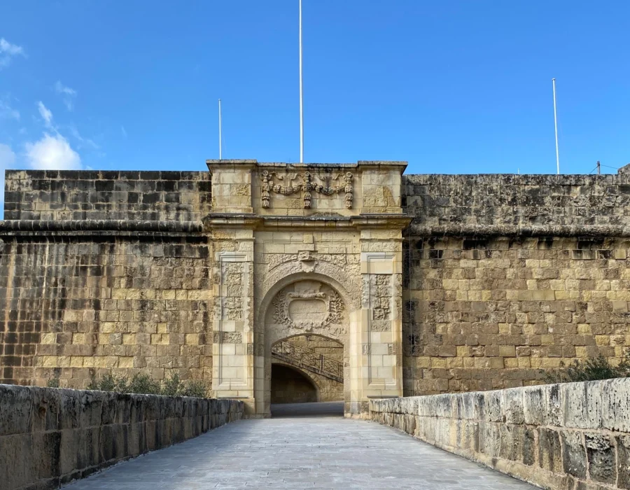 A historic stone gateway and bridge under a clear sky