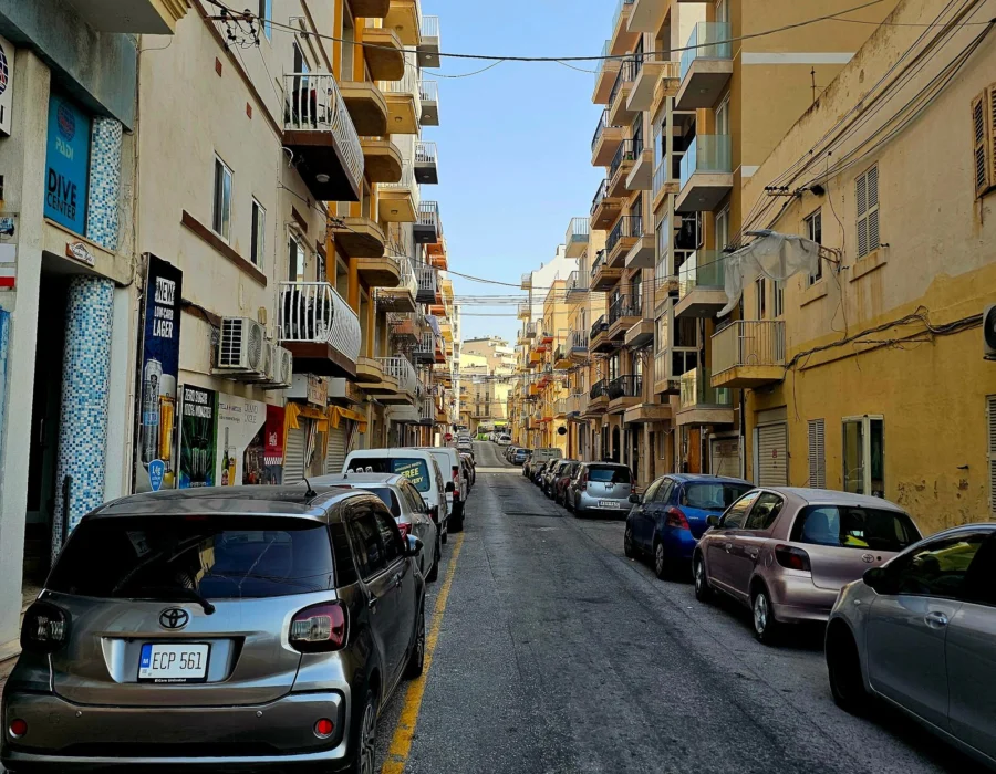 Cars parked along a narrow Maltese street