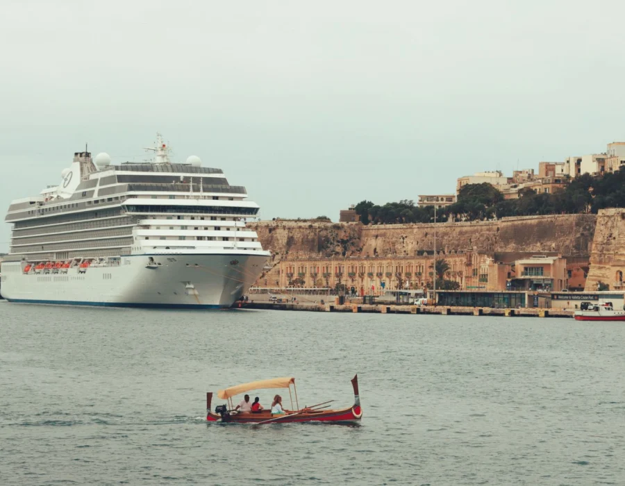 A cruise ship moored below the historic bastions of Valletta harbour