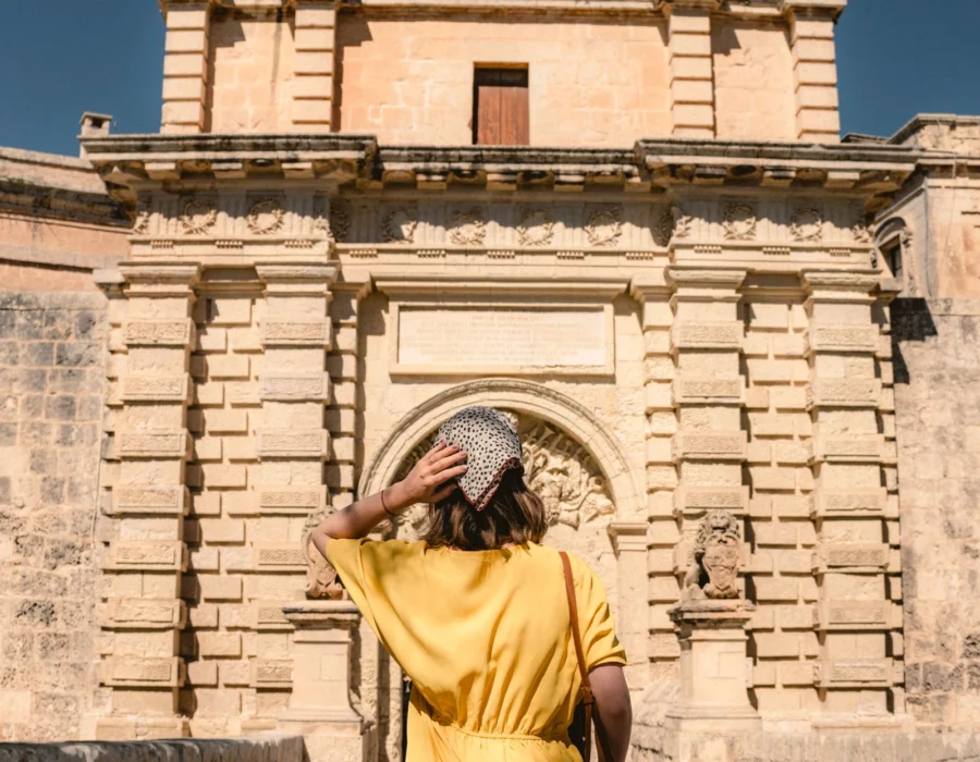 A visitor at the gate into Mdina