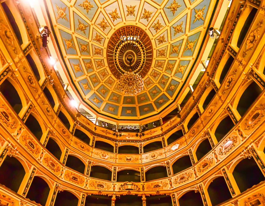 The gilded tiers of boxes and painted ceiling inside the Manoel Theatre