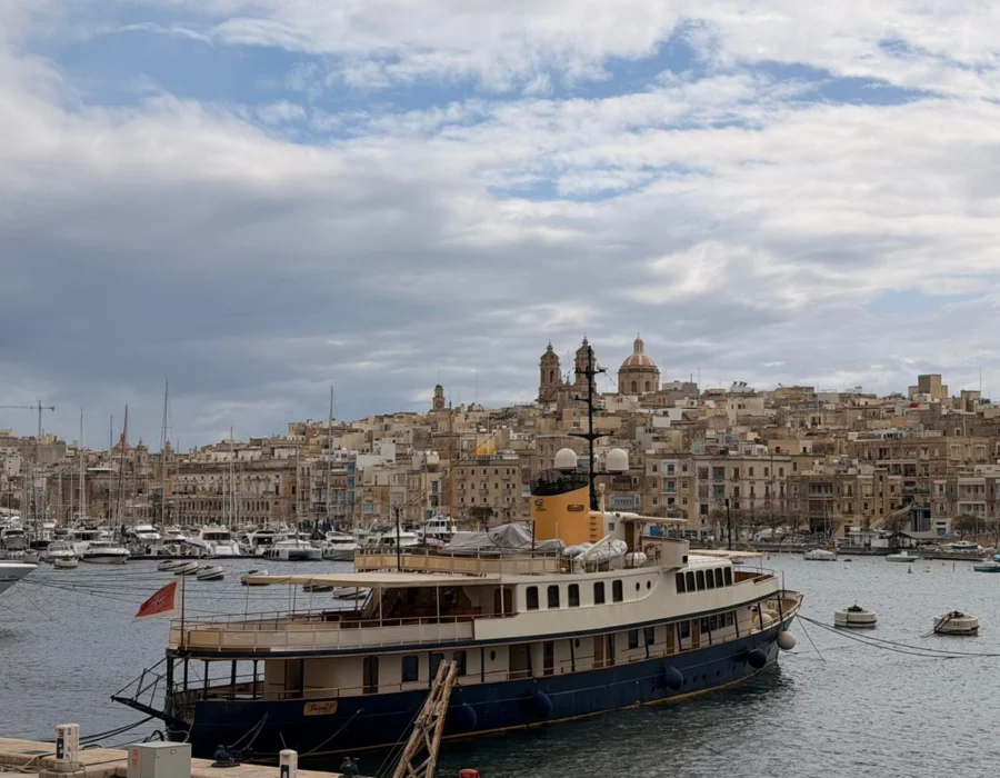 Boats moored along a Maltese marina waterfront