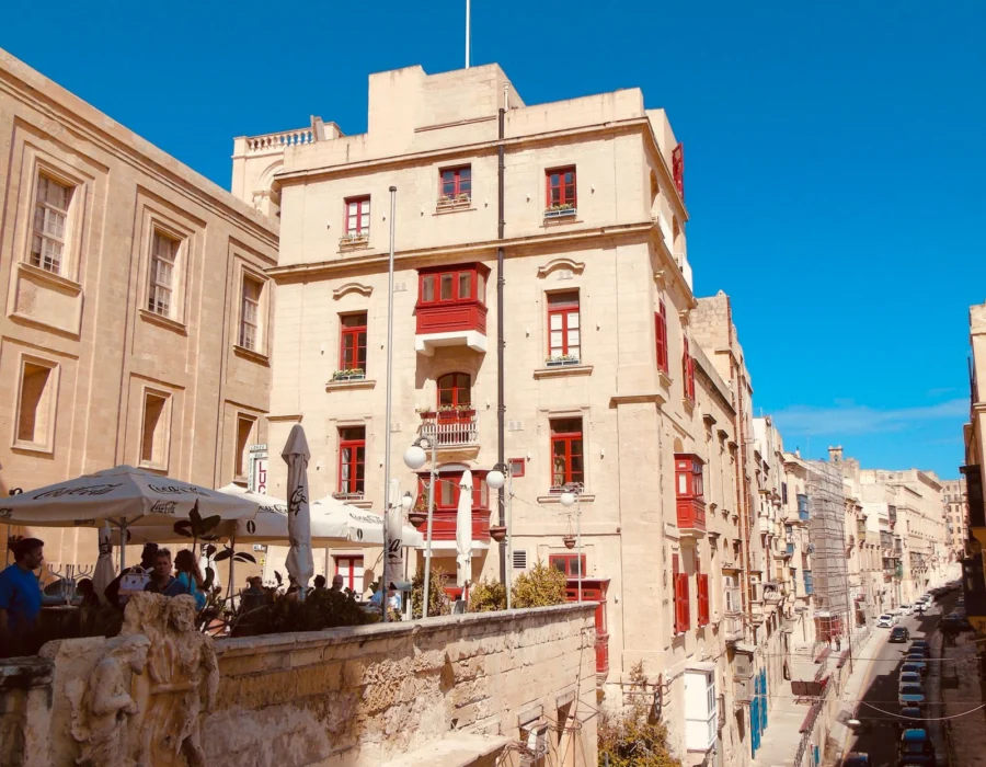 Bright sun on honey coloured limestone buildings in Valletta