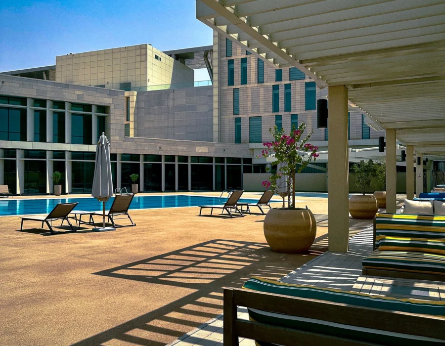 Sun loungers beside a pool at a summer lido