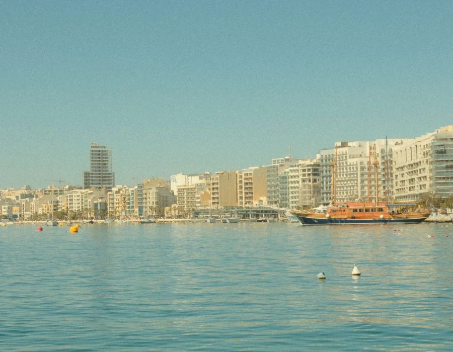 A sunny Maltese waterfront with modern buildings