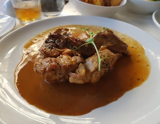 Maltese rabbit cooked in garlic and gravy