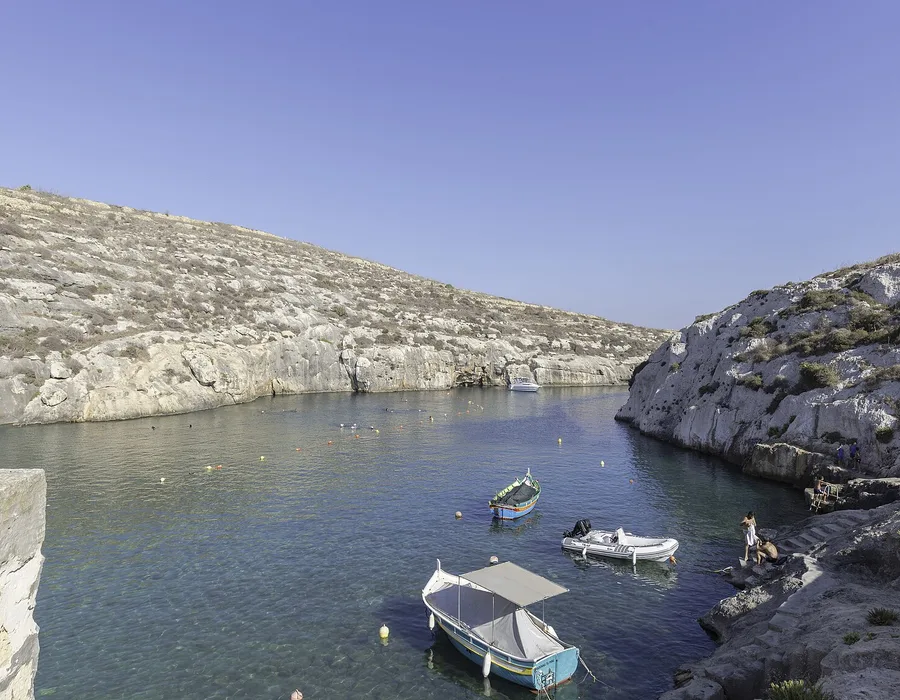 Small boats moored in the narrow inlet at Mġarr ix-Xini in Gozo