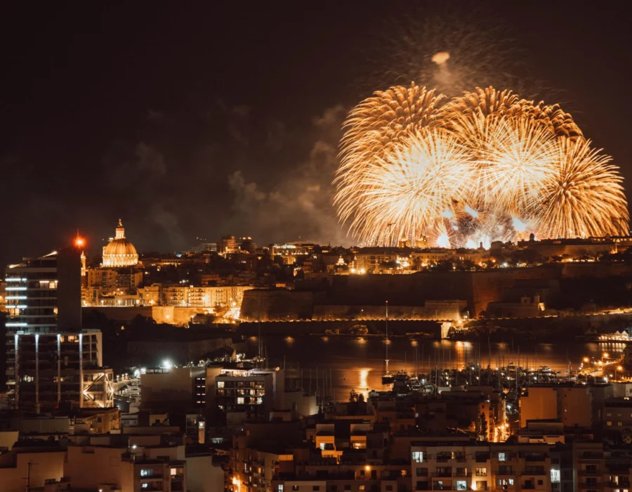 Fireworks bursting over the Valletta skyline at night