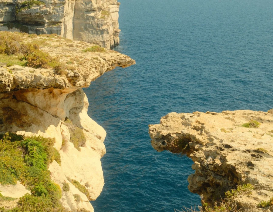 A cliff formation above deep blue sea in Malta