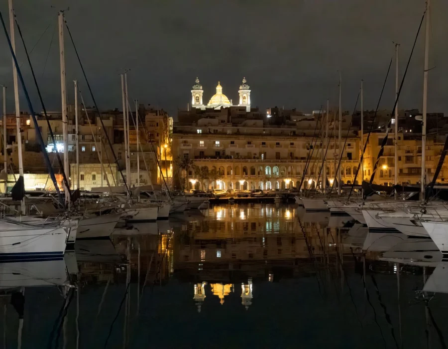 A Maltese waterfront illuminated at night