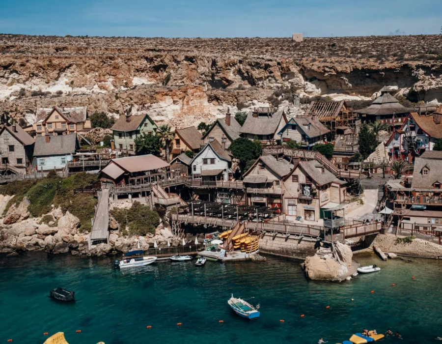 The colourful wooden houses of Popeye Village on the coast at Anchor Bay