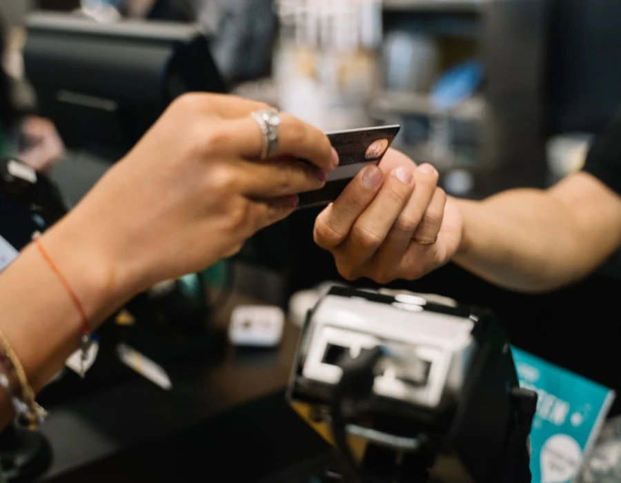 A person handing over a bank card