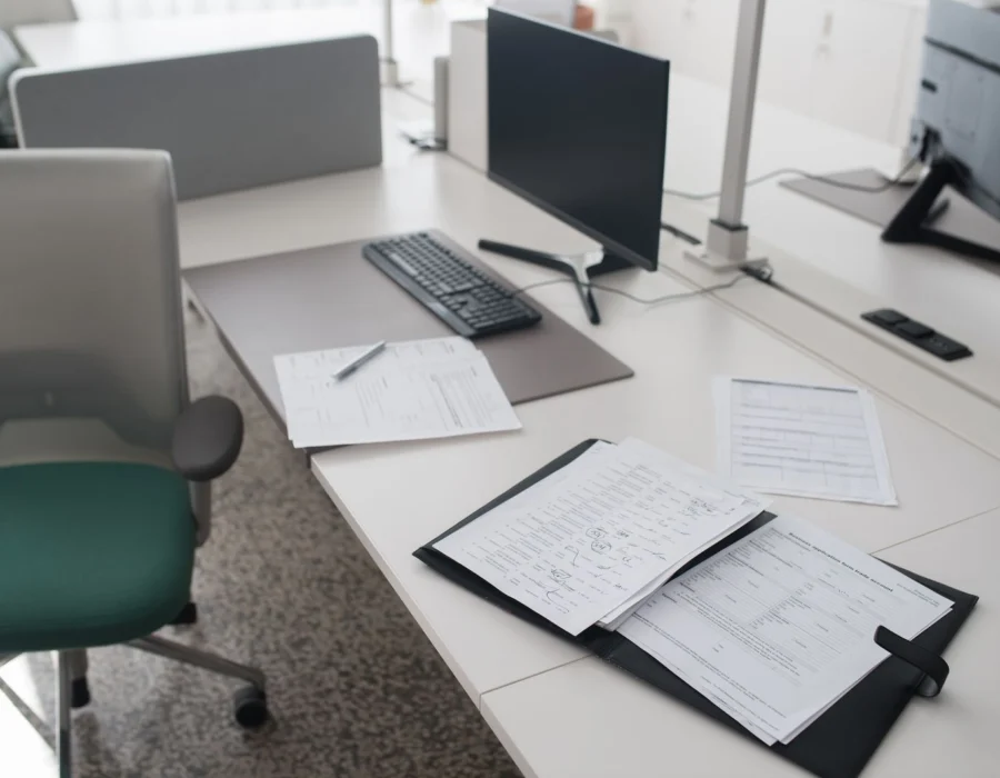 Documents in a binder on a desk