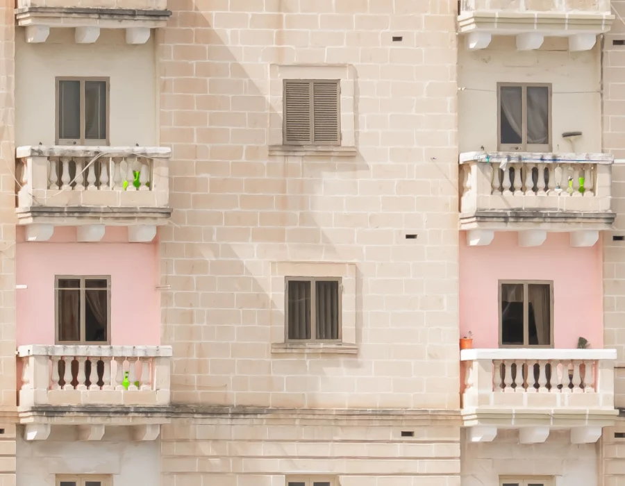 A Mediterranean apartment building with stone balconies
