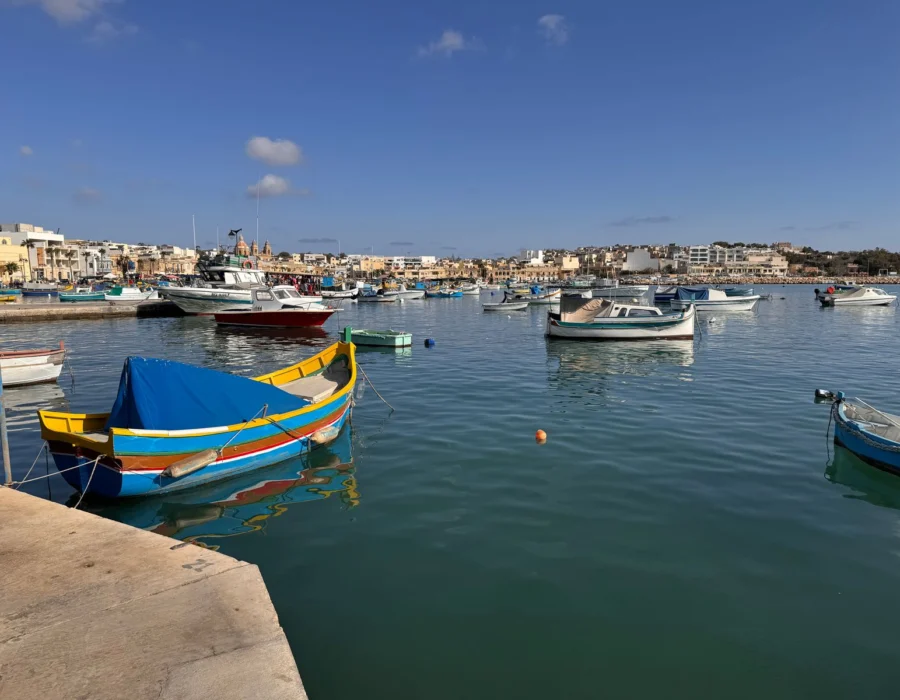 Painted luzzus moored along the Marsaxlokk waterfront