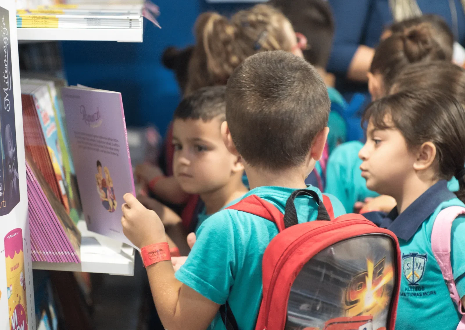 Children looking through books at a Malta Book Festival stand